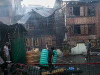 A residential house is collapsing as the fire is engulfing a congested neighborhood in Old City Srinagar, Indian Administered Kashmir, on Ju...