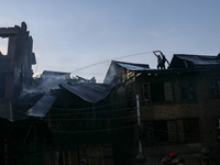 People are trying to douse the fire in a congested neighborhood in Old City Srinagar, Indian Administered Kashmir, on June 24, 2024. Several...