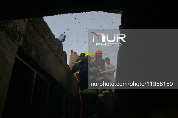 Firefighters are trying to douse the fire in a congested neighborhood in Old City Srinagar, Indian Administered Kashmir, on June 24, 2024. S...