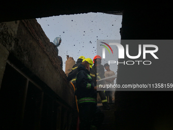 Firefighters are trying to douse the fire in a congested neighborhood in Old City Srinagar, Indian Administered Kashmir, on June 24, 2024. S...