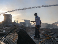 People are trying to douse the fire in a congested neighborhood in Old City Srinagar, Indian Administered Kashmir, on June 24, 2024. Several...