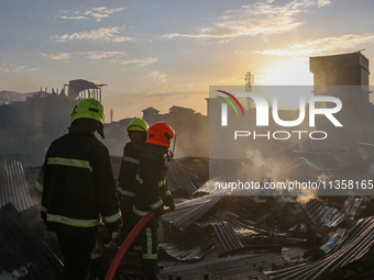 Firefighters are trying to douse the fire in a congested neighborhood in Old City Srinagar, Indian Administered Kashmir, on June 24, 2024. S...