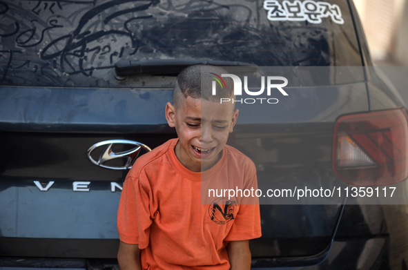 A mourner is reacting during the funeral of Palestinians killed in Israeli strikes, amid the Israel-Hamas conflict, at Al-Aqsa hospital in D...