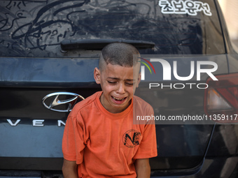 A mourner is reacting during the funeral of Palestinians killed in Israeli strikes, amid the Israel-Hamas conflict, at Al-Aqsa hospital in D...