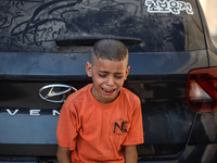 A mourner is reacting during the funeral of Palestinians killed in Israeli strikes, amid the Israel-Hamas conflict, at Al-Aqsa hospital in D...