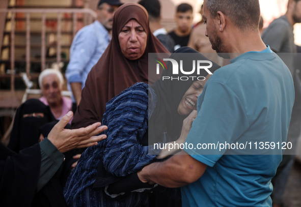 A mourner is reacting during the funeral of Palestinians killed in Israeli strikes, amid the Israel-Hamas conflict, at Al-Aqsa hospital in D...