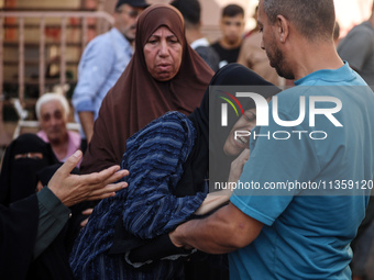 A mourner is reacting during the funeral of Palestinians killed in Israeli strikes, amid the Israel-Hamas conflict, at Al-Aqsa hospital in D...