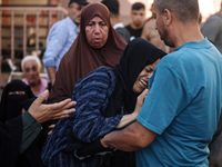 A mourner is reacting during the funeral of Palestinians killed in Israeli strikes, amid the Israel-Hamas conflict, at Al-Aqsa hospital in D...