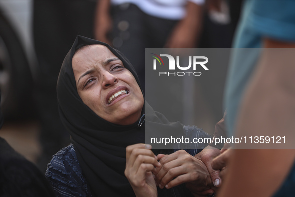 A mourner is reacting during the funeral of Palestinians killed in Israeli strikes, amid the Israel-Hamas conflict, at Al-Aqsa hospital in D...