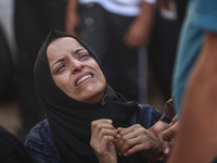 A mourner is reacting during the funeral of Palestinians killed in Israeli strikes, amid the Israel-Hamas conflict, at Al-Aqsa hospital in D...