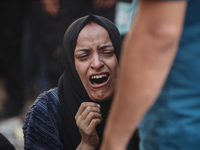 A mourner is reacting during the funeral of Palestinians killed in Israeli strikes, amid the Israel-Hamas conflict, at Al-Aqsa hospital in D...