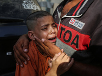 A mourner is reacting during the funeral of Palestinians killed in Israeli strikes, amid the Israel-Hamas conflict, at Al-Aqsa hospital in D...