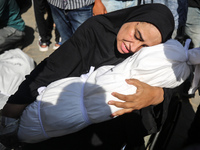 A mourner is reacting next to the bodies of Palestinians killed in Israeli strikes, amid the Israel-Hamas conflict, at Al-Aqsa hospital in D...