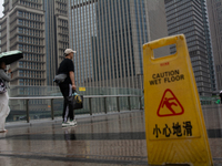 People are walking with umbrellas in Shanghai, China, on June 25, 2024, as China is issuing a rainstorm alert due to a deadly thunderstorm m...