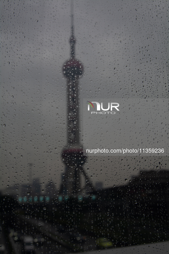 The Oriental Pearl TV Tower is being seen under the rain in Shanghai, China, on June 25, 2024, as China is issuing a rainstorm alert while a...