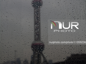 The Oriental Pearl TV Tower is being seen under the rain in Shanghai, China, on June 25, 2024, as China is issuing a rainstorm alert while a...