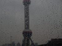 The Oriental Pearl TV Tower is being seen under the rain in Shanghai, China, on June 25, 2024, as China is issuing a rainstorm alert while a...