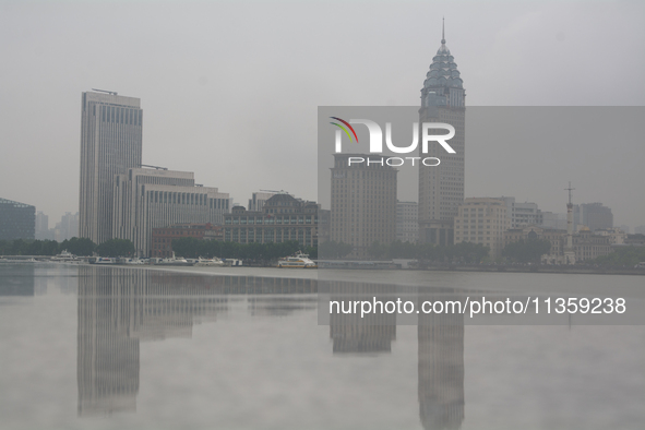 Reflection is being seen from Bingjiang Dadao along the Huangpu River in Shanghai, China, on June 25, 2024, as China is issuing a rainstorm...