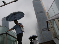 A man is walking with an umbrella at Lujiazui in Pudong in Shanghai, China, on June 25, 2024, as China is issuing a rainstorm alert as a dea...