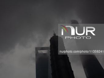 Skyscrapers are being seen under the heavy dark clouds at Lujiazui in Pudong in Shanghai, China, on June 25, 2024, as China is issuing a rai...