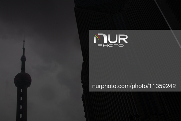 The Oriental Pearl TV Tower is being seen under heavy dark clouds at Lujiazui in Pudong in Shanghai, China, on June 25, 2024, as China is is...