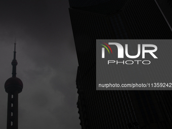 The Oriental Pearl TV Tower is being seen under heavy dark clouds at Lujiazui in Pudong in Shanghai, China, on June 25, 2024, as China is is...