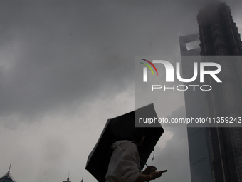 Skyscrapers are being seen under the heavy dark clouds at Lujiazui in Pudong in Shanghai, China, on June 25, 2024, as China is issuing a rai...