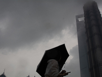 Skyscrapers are being seen under the heavy dark clouds at Lujiazui in Pudong in Shanghai, China, on June 25, 2024, as China is issuing a rai...