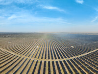 A new energy base is forming a blue ''photovoltaic ocean'' that is continuously producing green electricity in Zhongwei, China, on June 25,...