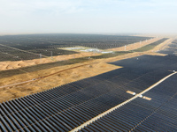 A new energy base is forming a blue ''photovoltaic ocean'' that is continuously producing green electricity in Zhongwei, China, on June 25,...