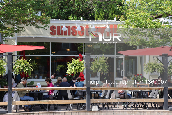 People are eating on a restaurant patio in Niagara-on-the-Lake, Ontario, Canada, on June 12, 2024. 