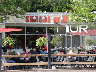 People are eating on a restaurant patio in Niagara-on-the-Lake, Ontario, Canada, on June 12, 2024. (