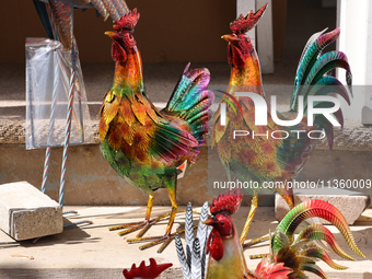 Metal roosters are being displayed outside a shop in Niagara-on-the-Lake, Ontario, Canada, on June 12, 2024. (