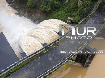 An aerial photo is showing the flood discharge at the Yongli Hydropower Station in Congjiang County, Southwest China's Guizhou Province, on...