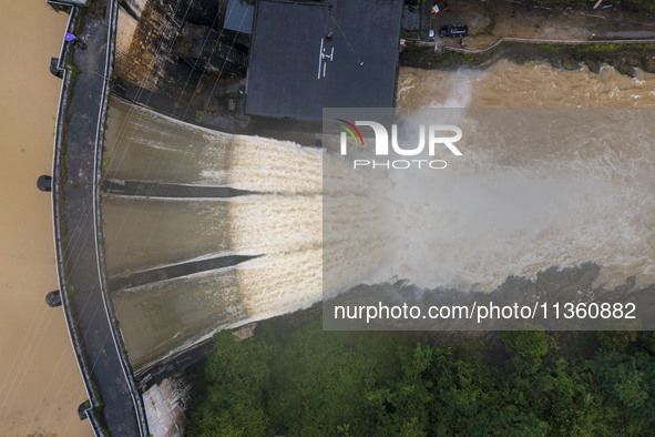 An aerial photo is showing the flood discharge at the Yongli Hydropower Station in Congjiang County, Southwest China's Guizhou Province, on...