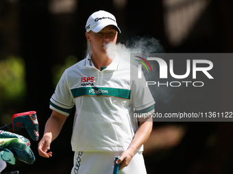 Charley Hull of England smokes as she waits on the second green during Day Four of the KPMG Women's PGA Championship at Sahalee Country Club...