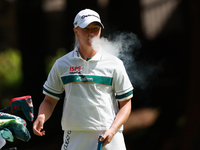 Charley Hull of England smokes as she waits on the second green during Day Four of the KPMG Women's PGA Championship at Sahalee Country Club...