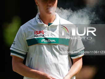 Charley Hull of England smokes as she waits on the second green during Day Four of the KPMG Women's PGA Championship at Sahalee Country Club...