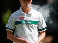 Charley Hull of England smokes as she waits on the second green during Day Four of the KPMG Women's PGA Championship at Sahalee Country Club...