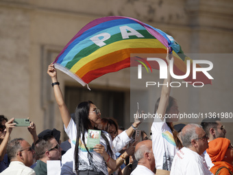 People are holding Peace flags during Pope Francis' weekly general audience in St. Peter's Square in The Vatican, on June 26, 2024. (