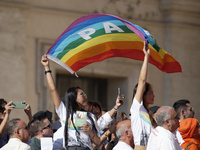 People are holding Peace flags during Pope Francis' weekly general audience in St. Peter's Square in The Vatican, on June 26, 2024. (