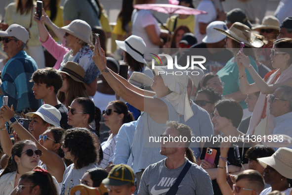 People are taking photos during Pope Francis' weekly general audience in The Vatican, on June 26, 2024, at St. Peter's Square. 