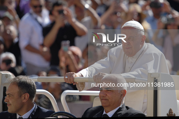 Pope Francis is arriving for his weekly general audience in St. Peter's Square at the Vatican, on June 26, 2024. 