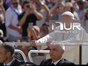 Pope Francis is arriving for his weekly general audience in St. Peter's Square at the Vatican, on June 26, 2024. (