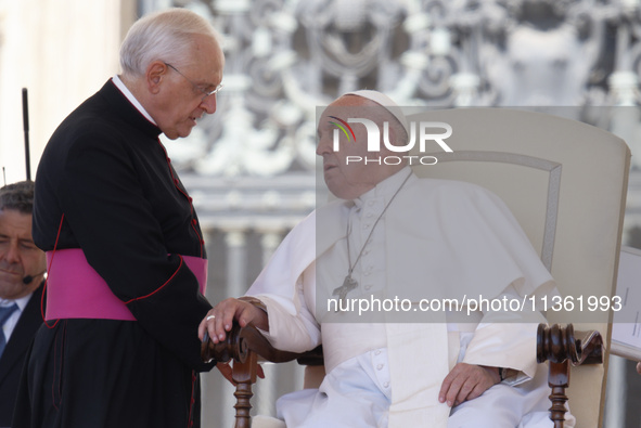 Pope Francis is talking with Padre Leonardo Sapienza at the end of his weekly general audience in The Vatican, on June 26, 2024, at St Peter...