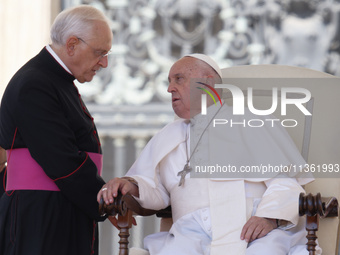 Pope Francis is talking with Padre Leonardo Sapienza at the end of his weekly general audience in The Vatican, on June 26, 2024, at St Peter...