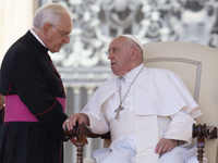 Pope Francis is talking with Padre Leonardo Sapienza at the end of his weekly general audience in The Vatican, on June 26, 2024, at St Peter...