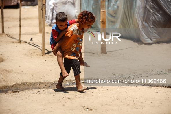 Displaced Palestinian children are playing outside their tent in Deir el-Balah, on June 26, 2024, amid the ongoing conflict between Israel a...