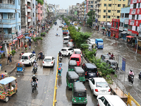 Vehicles and rickshaws are trying to drive with passengers through the waterlogged streets caused by heavy monsoon rainfalls in Dhaka, Bangl...