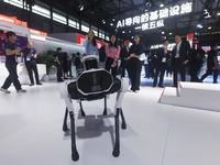 Visitors are interacting with intelligent robot dogs at the 2024 Mobile World Congress (MWC Shanghai) in Shanghai, China, on June 26, 2024....